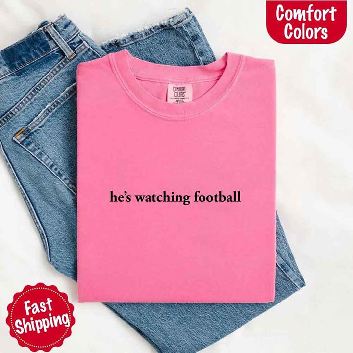 He’s Watching Football Tee - Comfort Colors Funny Shirt for Her
