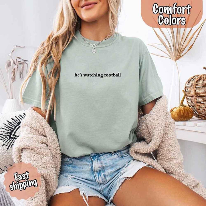 He’s Watching Football Tee - Comfort Colors Funny Shirt for Her