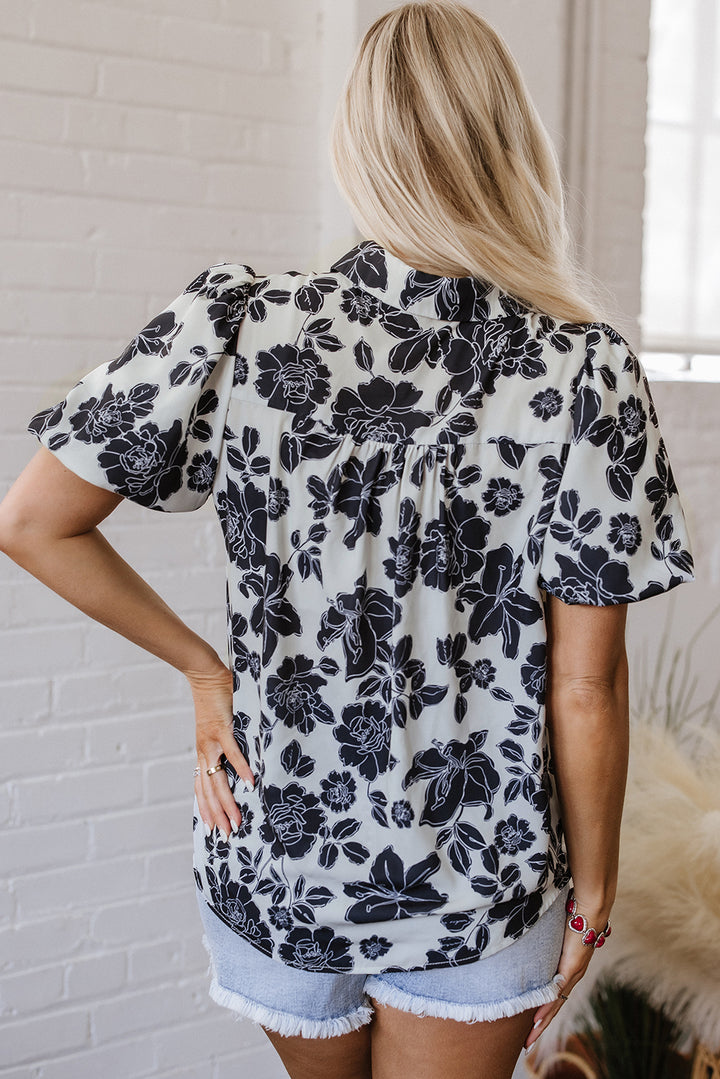 Chemise décontractée noire à manches bouffantes et motif floral